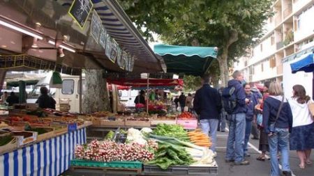 Trying our language skills at an open market in France.