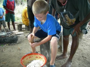 Luke taking a turn scraping coconut