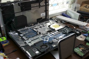 Our iMac with the glass removed and the LED display rotated out of the way. The empty bay where the old Hard Drive was is in the middle.