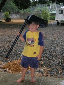 Jonathan Jordan uses a dustpan for an umbrella.