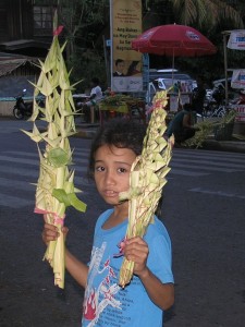 Filipino boy selling palms as the worshippers come to church