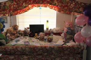 Joy's bears and favorite things on her bed