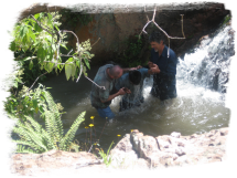 New tribal believers being baptized in the mountains