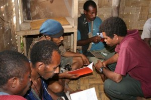 A Mibu man teaches others to read.