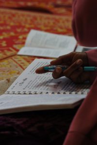 A Prai woman follows along in the Bible lesson