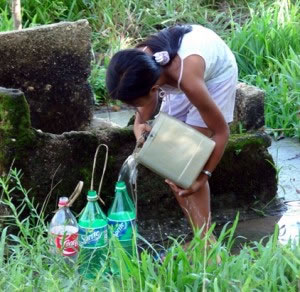 An Agutaynen woman makes sure all her water bottles are full.
