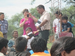 Manjúi pastor (who Leah's dad discipled) passing out Bibles.