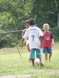 Ethan & Josiah playing soccer with the local boys.