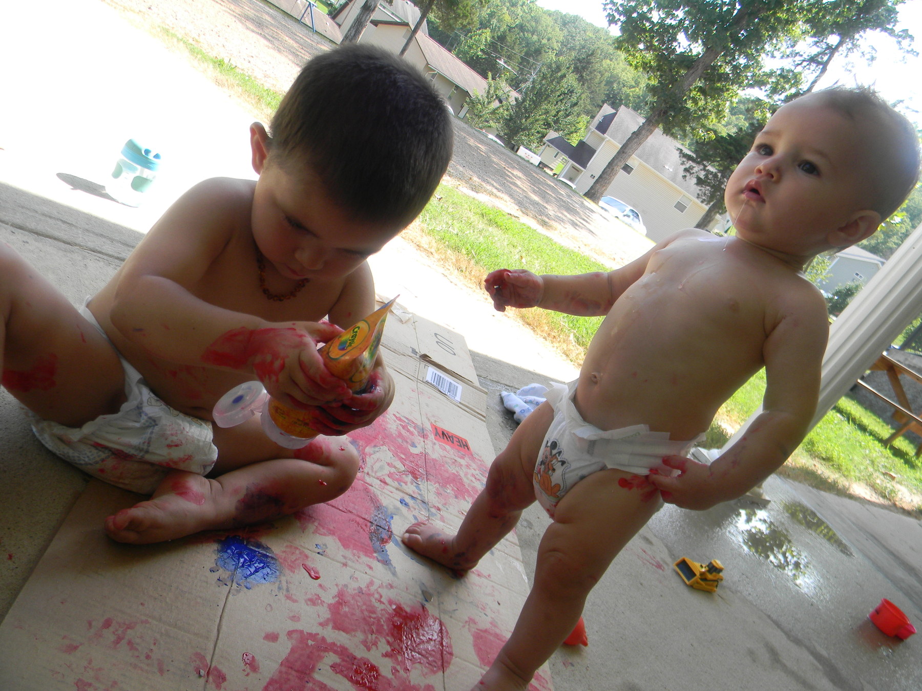 Gotta love finger paint (and  hoses to shower off they boys afterward)