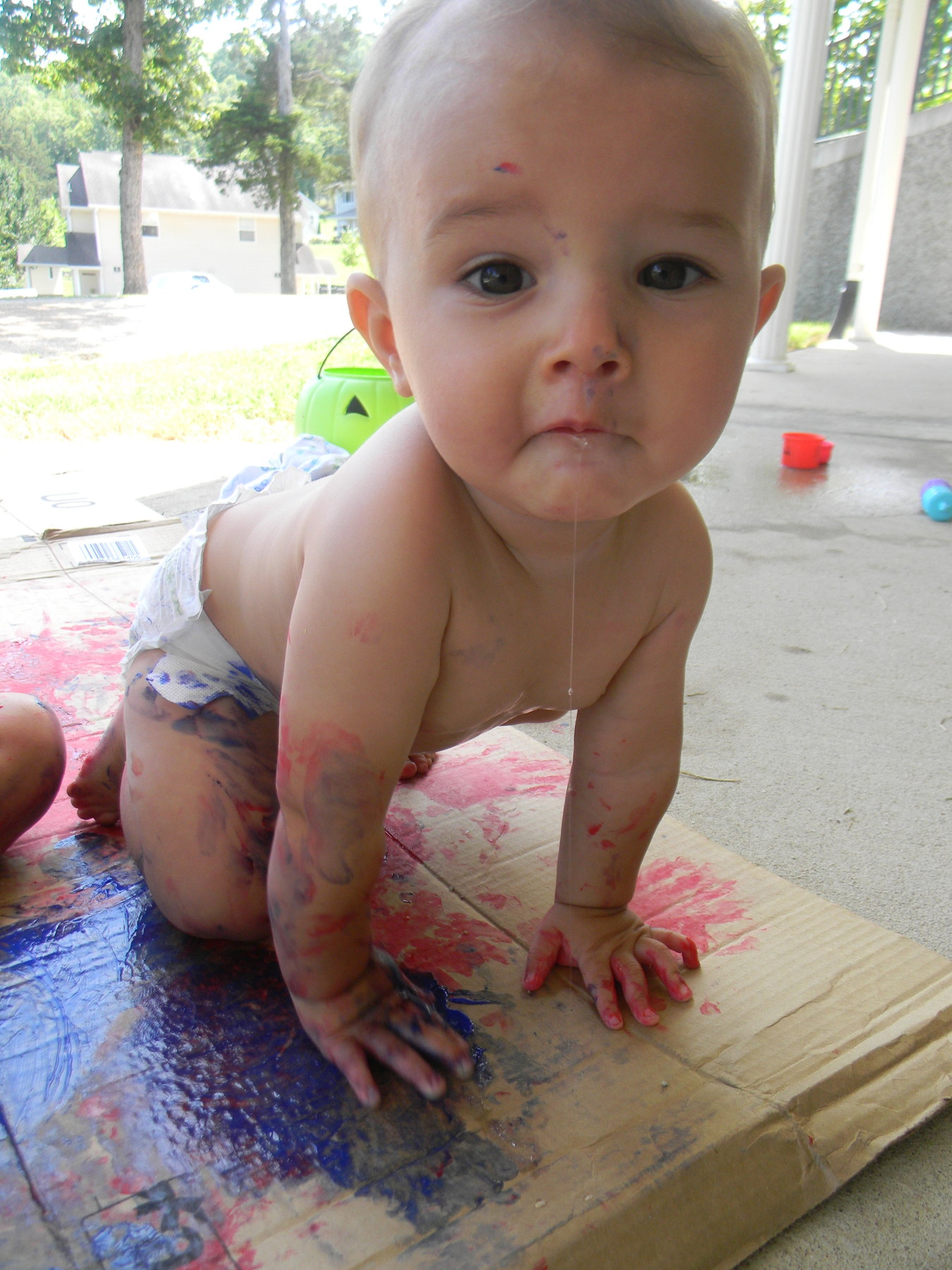 Baby boy with lots of paint and lots of drool