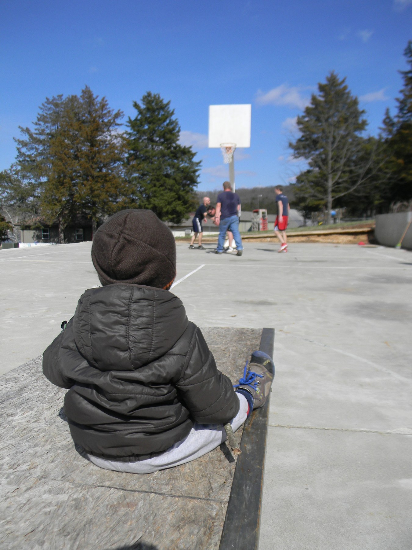 Watching Daddy play basketball. Elias ran out on the field twice wanting to join the fun! That kid loves balls!