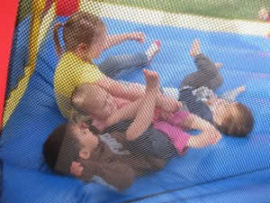 Cousin pile-up on the bouncy toy