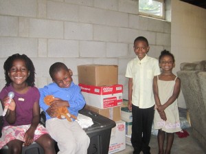 The kids next to some of what we have packed so far