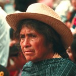 Native Mexican lady in a green striped shirt and straw-colored hat