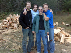 Logan, Josh, Rob, and Jordan outside after a few days of stacking wood