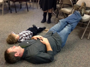 Titus and Matt laying on the floor of Peaceful Valley Church
