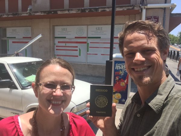 Jordan and Amy holding up one of their kid's Mexican passports