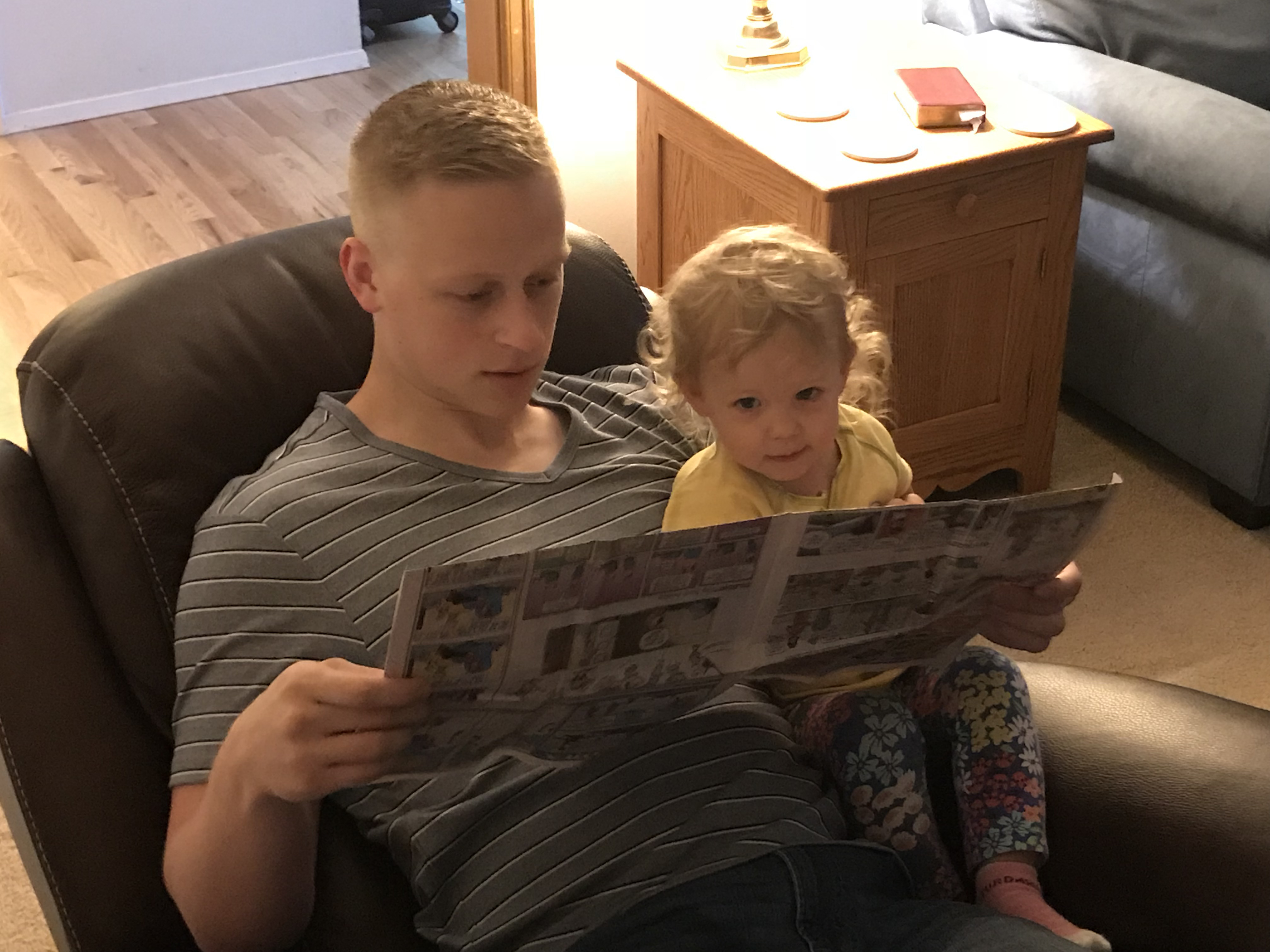 Jordan's brother Joseph reading with Lily at Jordan's parents' house