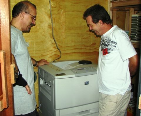 Jason and Lance watching the printer as the 1st copy of the Tala-Andig New Testament is printed!