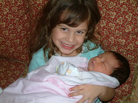 Big Sister Natania holds Baby Thalia