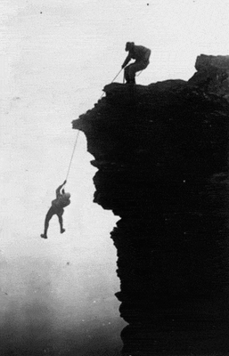 guy-hanging-off-a-cliff-on-a-rope[1]