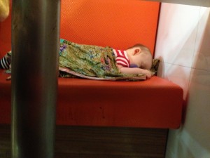 Sleeping in a booth at a restaurant at the mall before the bus ride home.