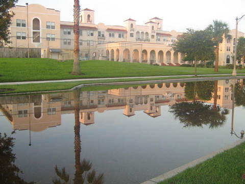 lakeside view of water-covered street behind the mission building