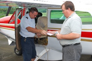 Bush pilot hands letter to supply man