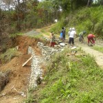 Men at work repairing a washed out I'wak road.