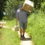 Geoff Harada carrying just one of many heavy boxes into his tribal station. 
