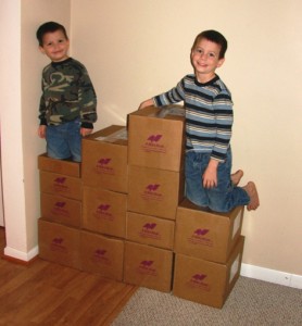Luke and Jonathan with all their homeschooling books for the next five years