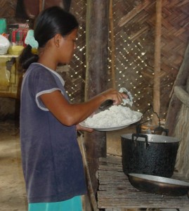 An Agutaynen teenager with a plate full of cooked rice.