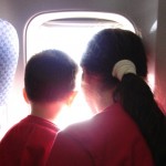 Jonathan and Rebekah looking out a window on the airplane
