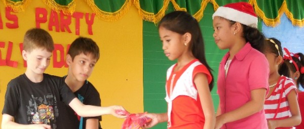 Luke handing out gifts at school