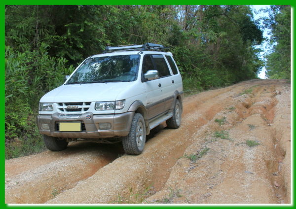 Our vehicle going down a washed-out road in the village.