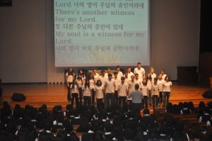 Concert choir singing at a school in Korea (Abby is in the front left)