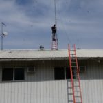 James is removing some unused wireless equipment from the roof o the headquarters building.